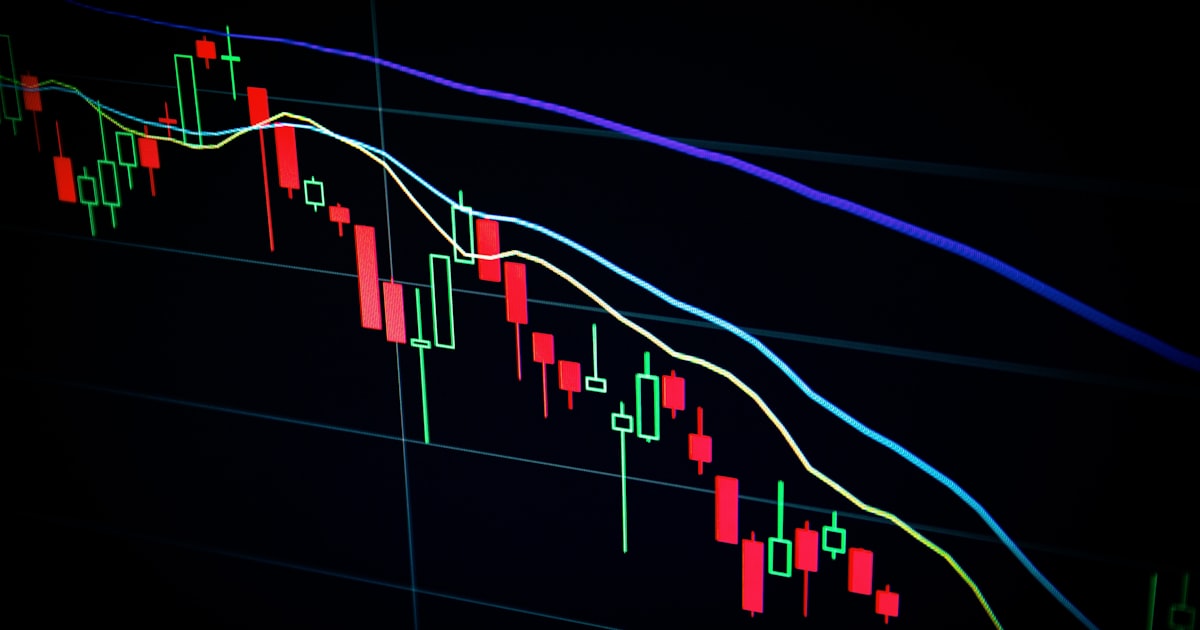 Stock market trading charts and investment data on screens