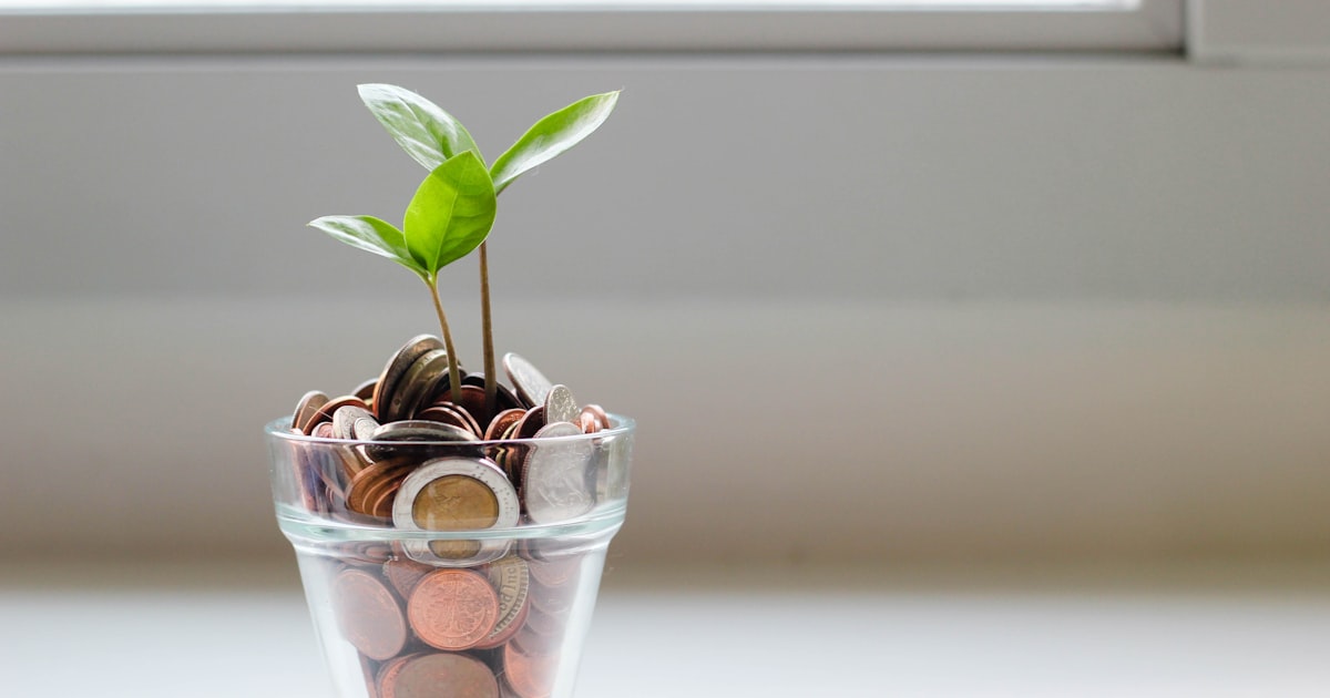 Coins in a glass jar representing retirement savings growth