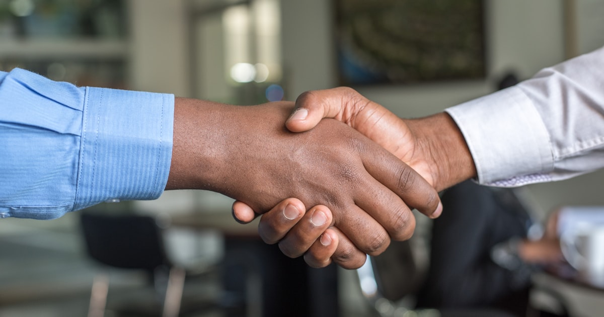 Business professionals shaking hands on a deal