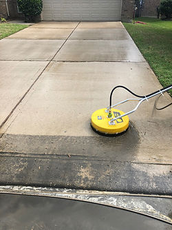 Pressure washing a concrete driveway