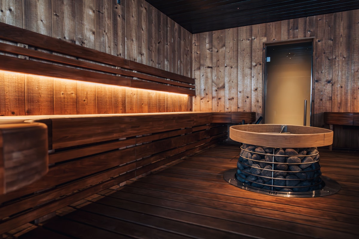 Interior of a traditional wood sauna with a heater full of hot stones