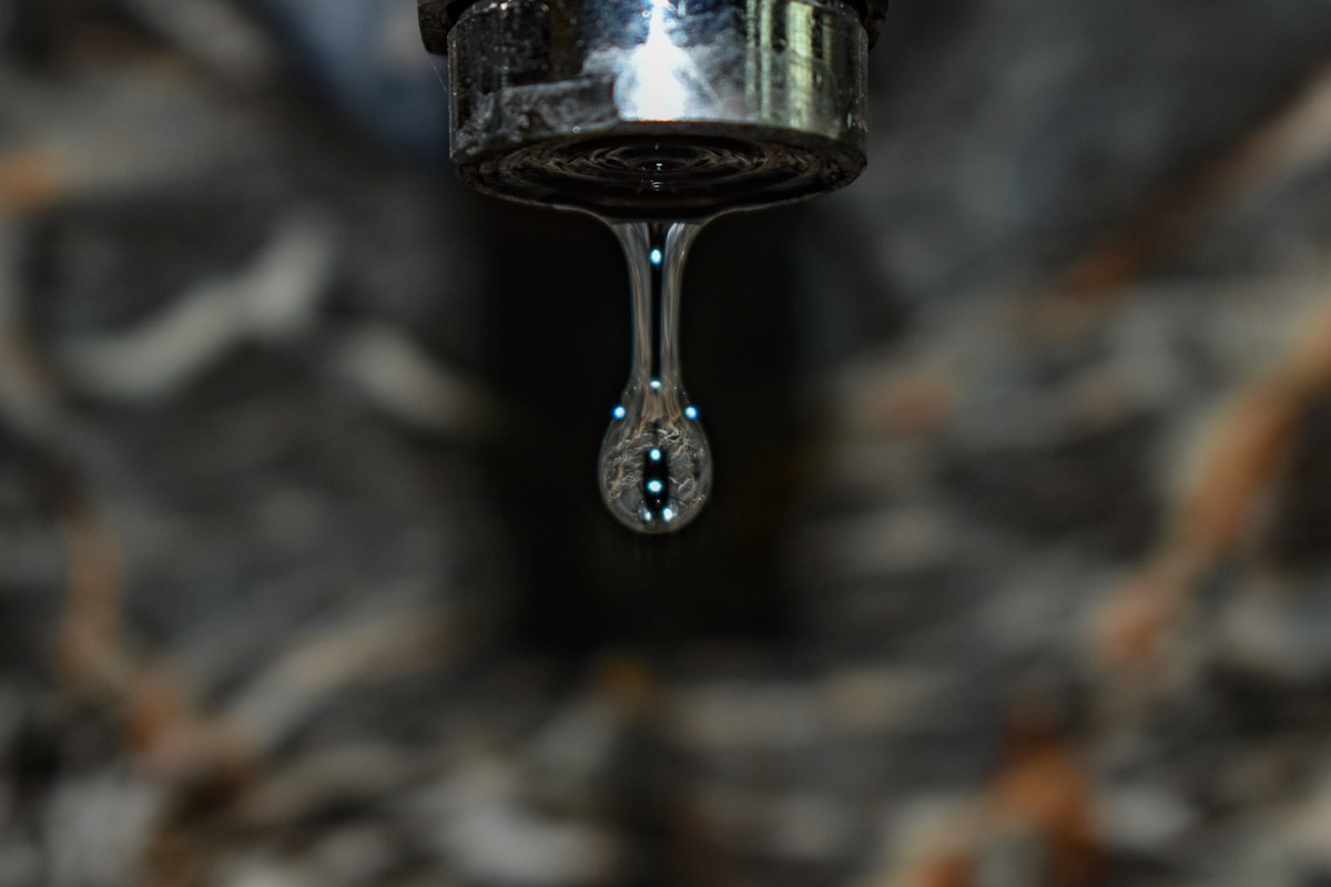 Close-up of a dripping faucet water drop