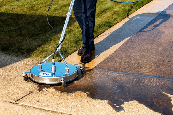 Pressure washing a concrete driveway
