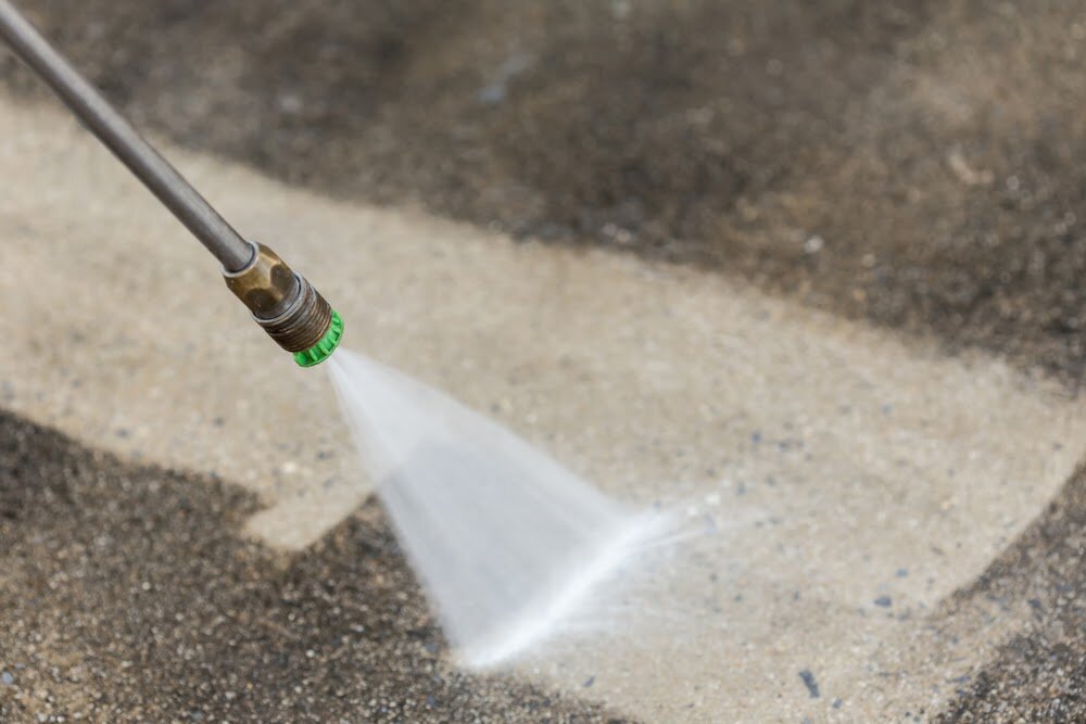 Cleaning a garage floor and exterior with pressure washing