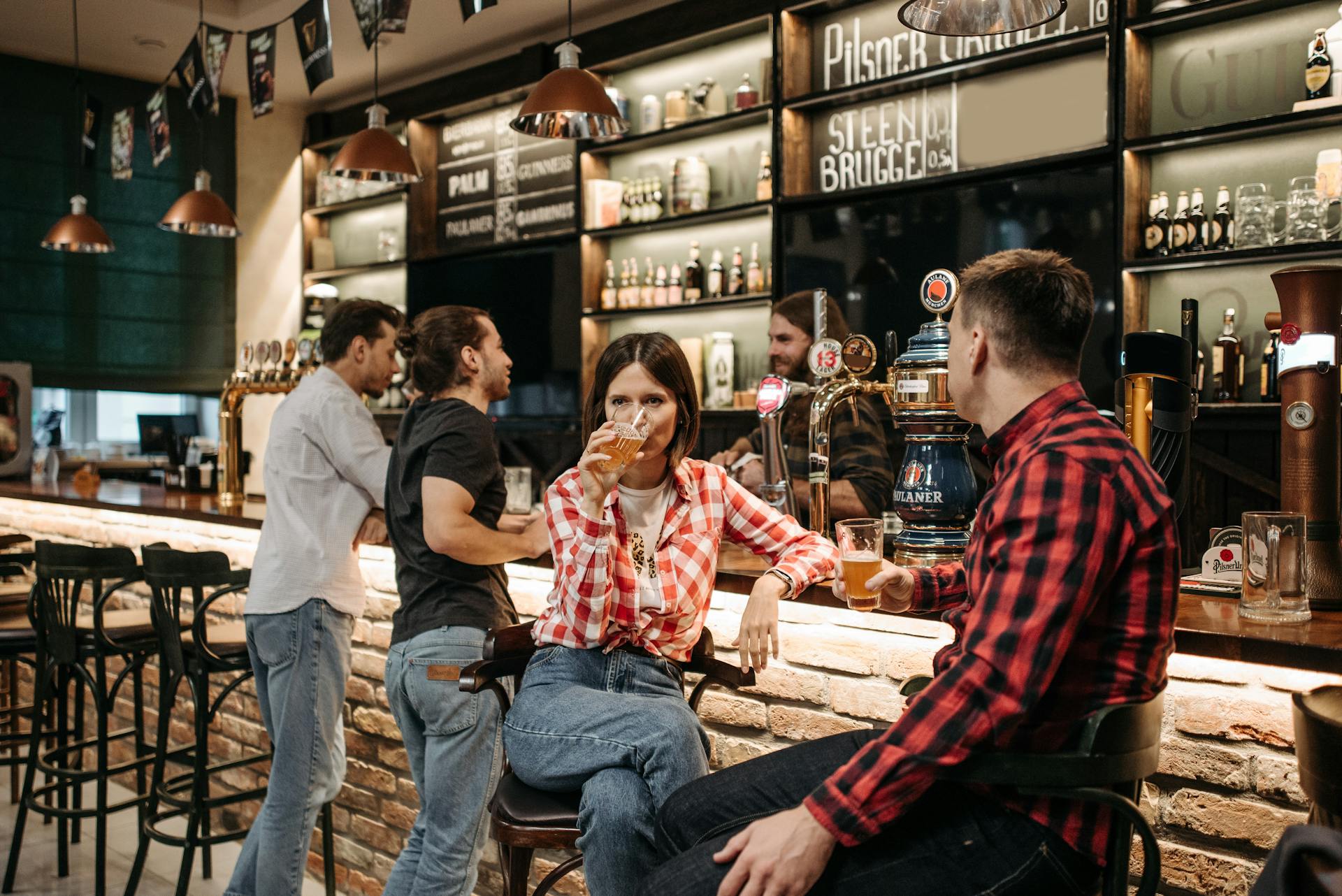 Stock photo of a tidy group at a bar, unrealistically sober compared to Beer Run finishers