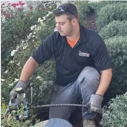 Lanz technician clearing a household drain line with a professional drain machine