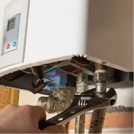 Tankless water heater mounted on a utility room wall
