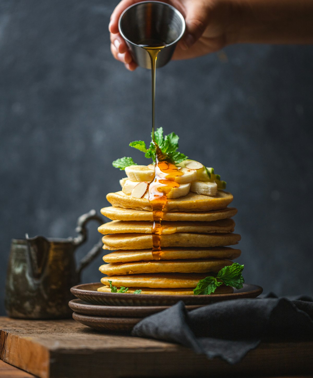 Stack of pancakes drenched in maple syrup