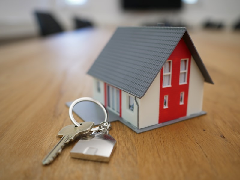 House keys and a small model home representing the housing market