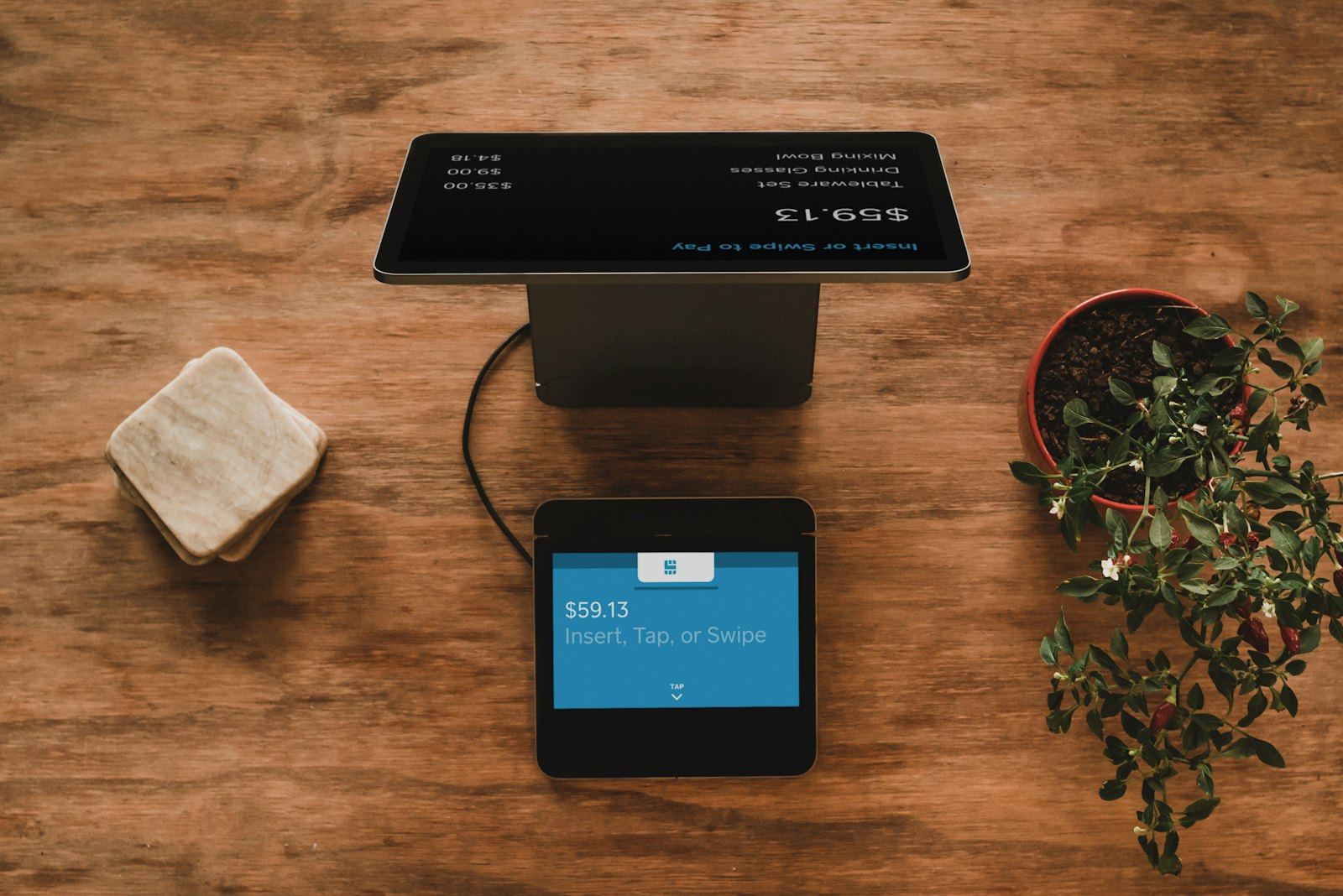 Stock charts and a tablet on a desk illustrating ETF and mutual fund comparison.