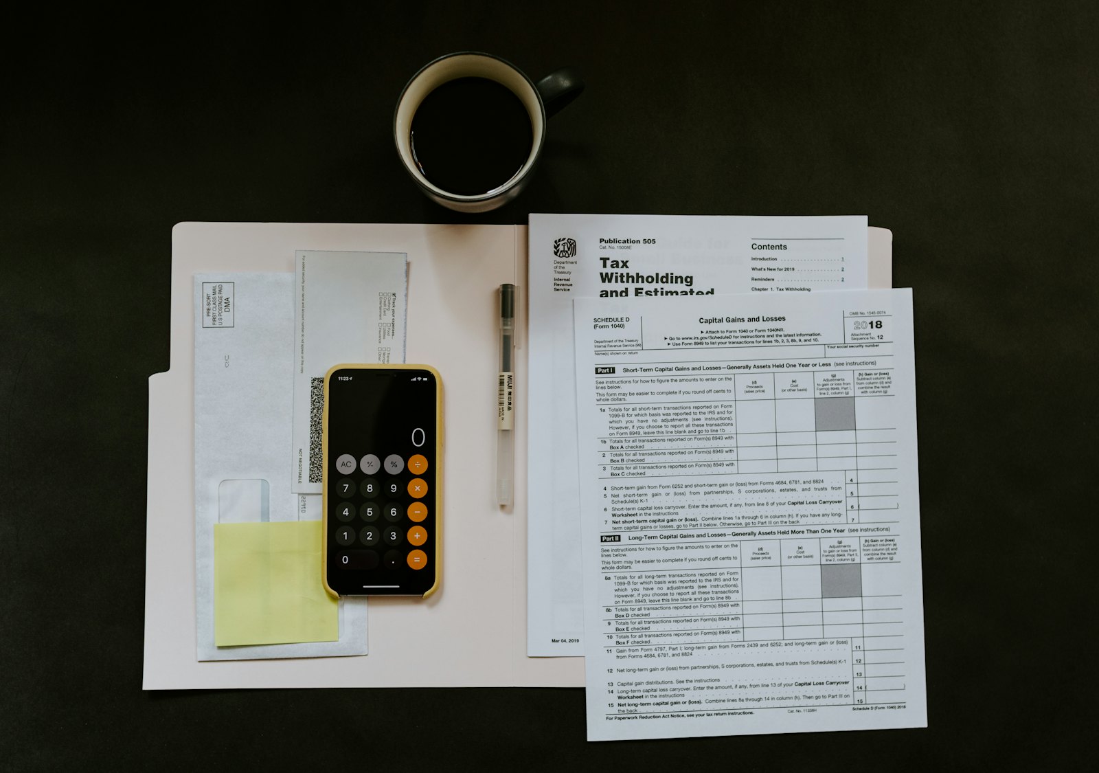 A financial advisor reviewing documents with a client at a wooden table.