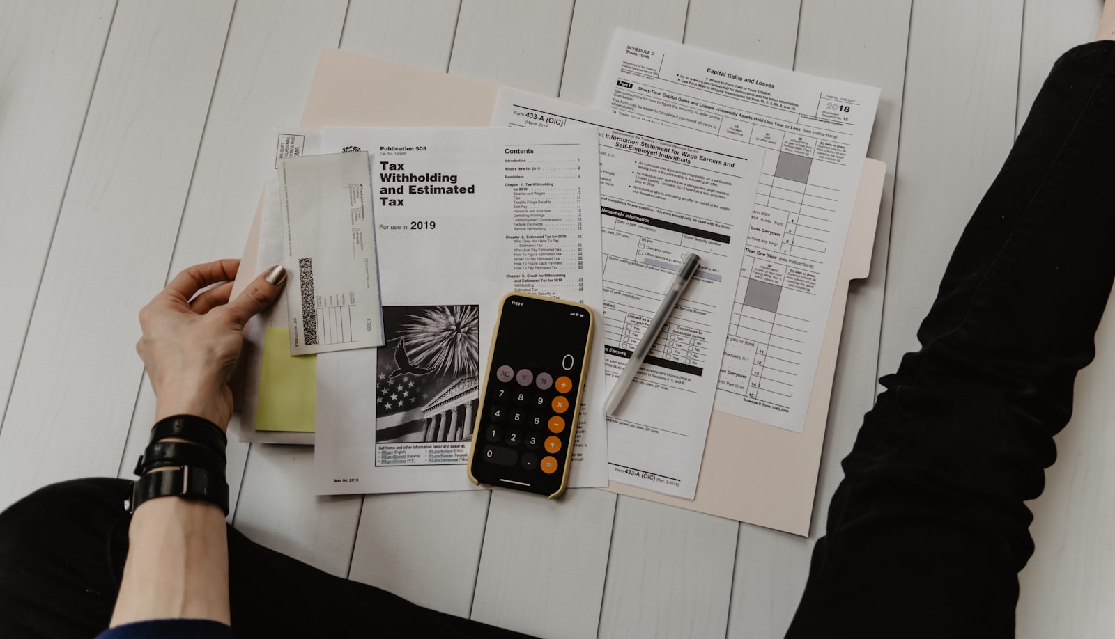 Retired couple reviewing financial documents at a sunlit kitchen table.