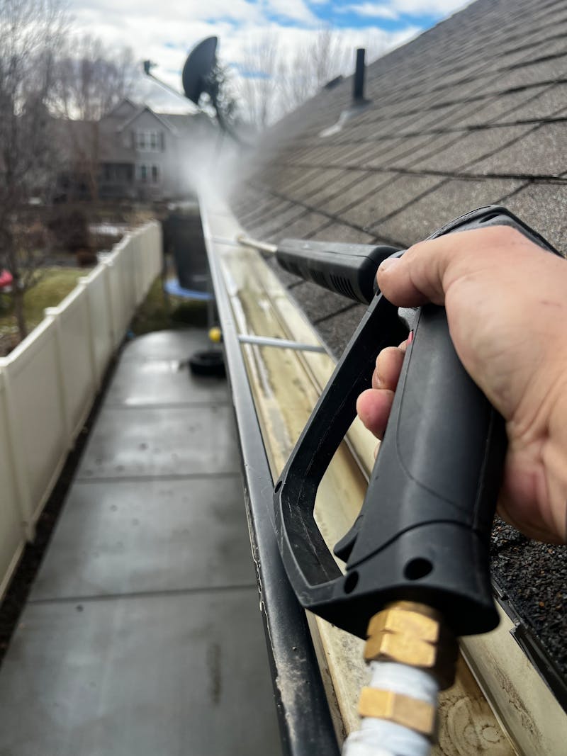 Professional cleaning of residential gutters to remove debris