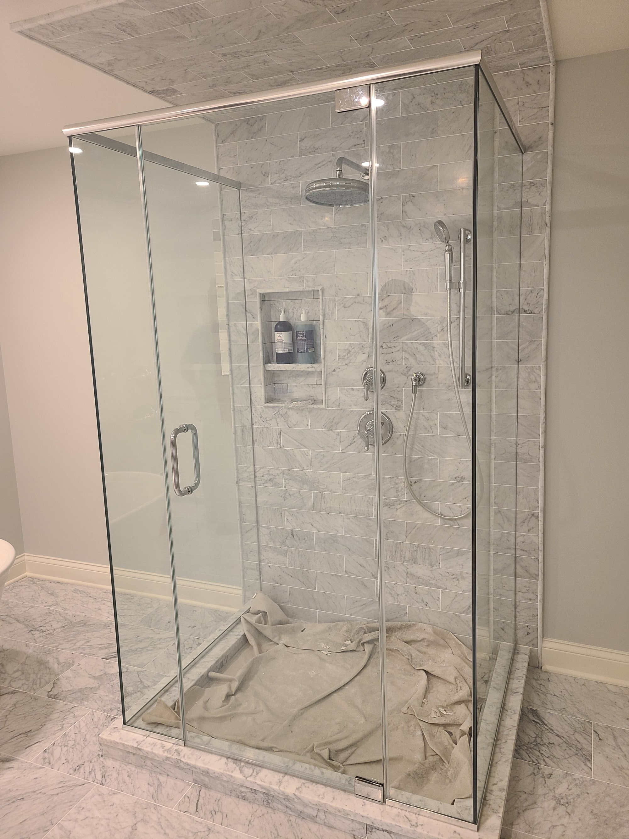 Frameless glass shower with minimal hardware