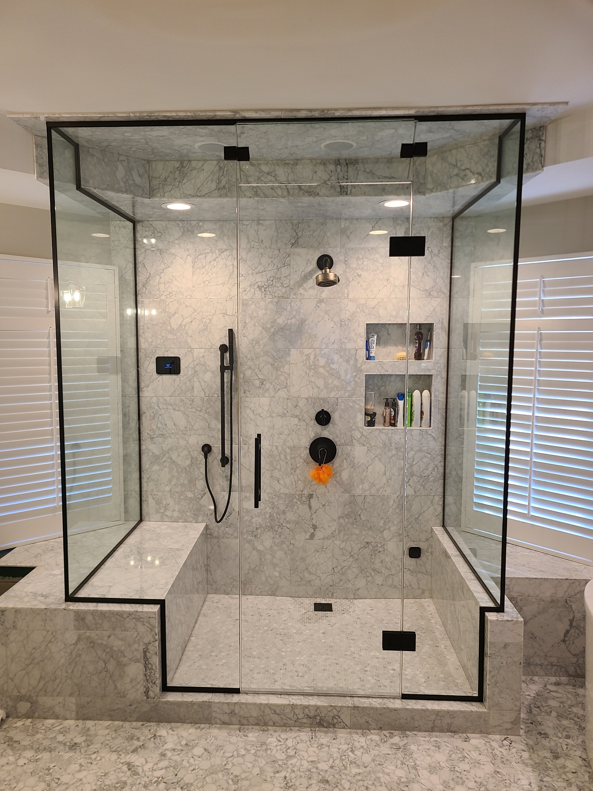 Custom glass shower with brushed hardware