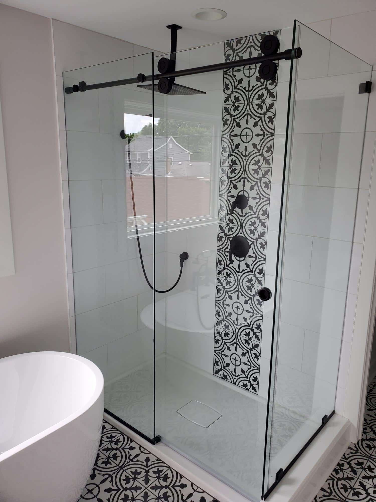 Custom glass shower pairing with custom tile work