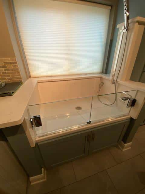 Step-in glass shower enclosure
